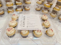 cupcakes in plastic containers on a table